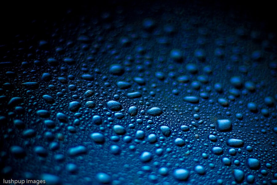 water droplets consdensed onto a shiny blue surface