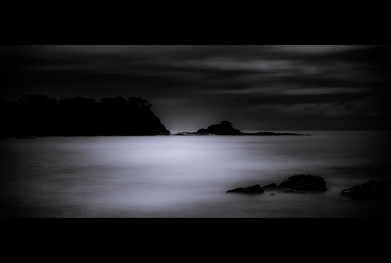 Long exposure of coastal headland by moonlight