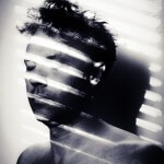 Monochrome self portrait with white light bars across my face