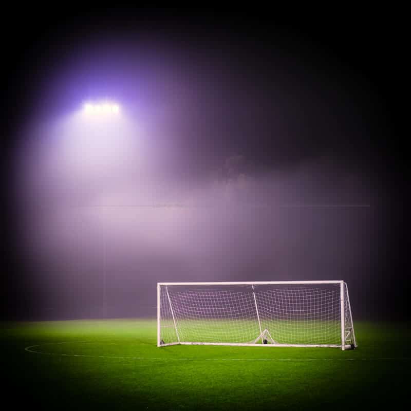 Goal lit by misty lights on green